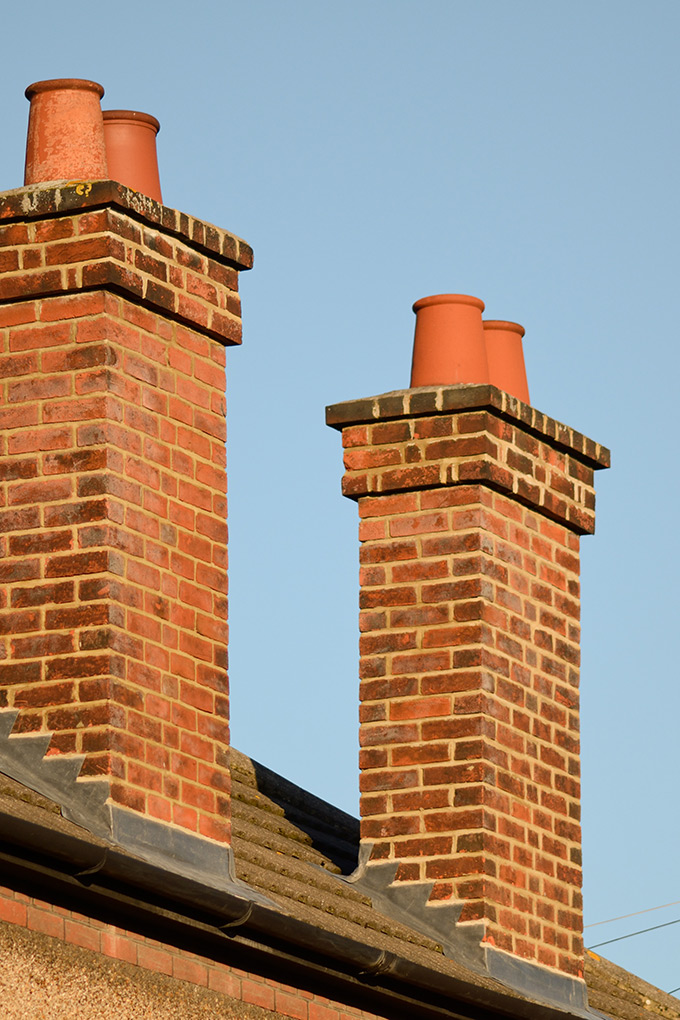 Close up of two brick chimneys